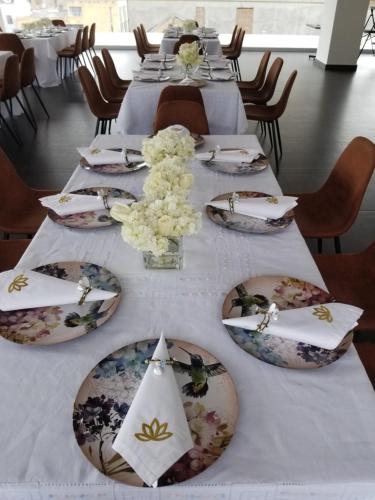 Hotel Amiraty في إبياليز: طاولة عليها صحون و ورد