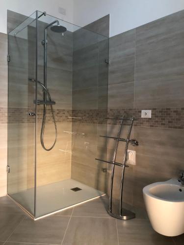 a bathroom with a glass shower and a sink at Casa Magnolia in Pastrengo