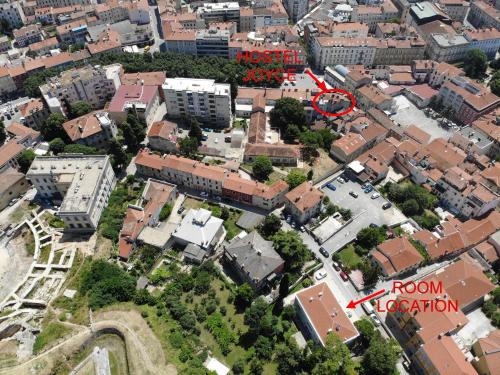 an aerial view of a city with a red sign at Boutique Suites Joyce in Pula