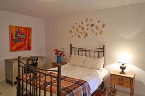 a bedroom with a bed and a clock on the wall at Apatouria Farmhouse in Andros