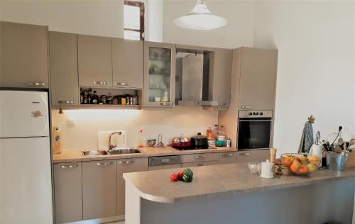 a kitchen with a counter with fruits and vegetables on it at Apatouria Farmhouse in Andros