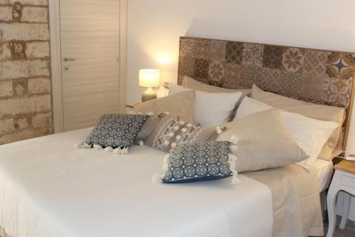 a bedroom with a white bed with two pillows on it at Il Trappeto in Vieste