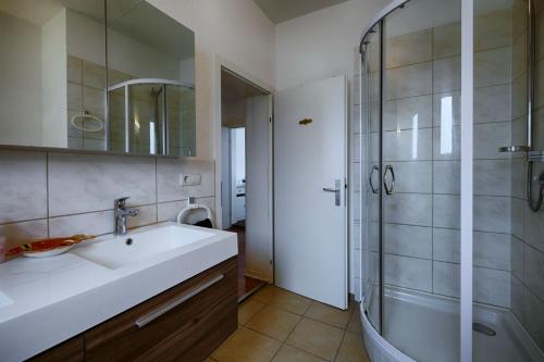 a bathroom with a sink and a shower at Haus Rabenswalde in Garnbach