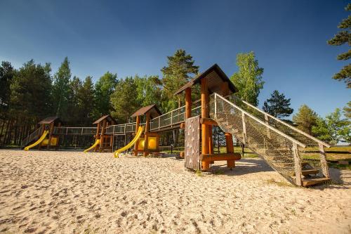 a row of playground equipment in the sand at Dzintarkrasts in Žocenes Ciems