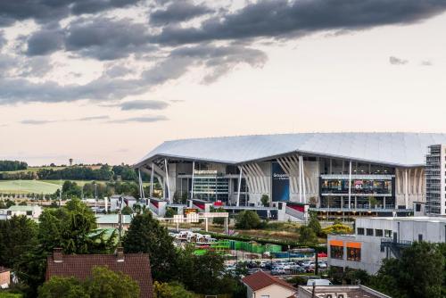 a view of a large building in a city at Kyriad Lyon Est Stadium Eurexpo Meyzieu in Meyzieu