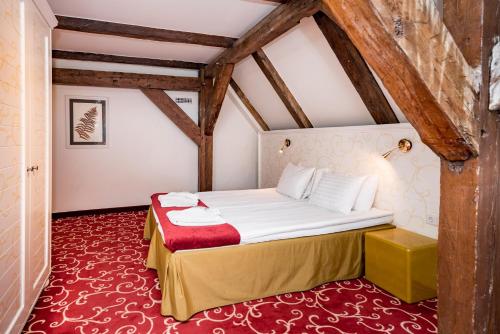 a bedroom with a bed in a attic at Meriton Old Town Garden Hotel in Tallinn