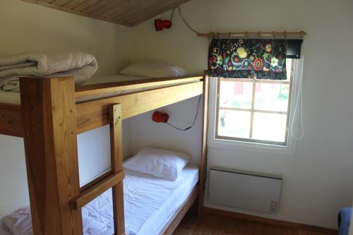 a bedroom with two bunk beds and a window at Café Björnen in Västerås