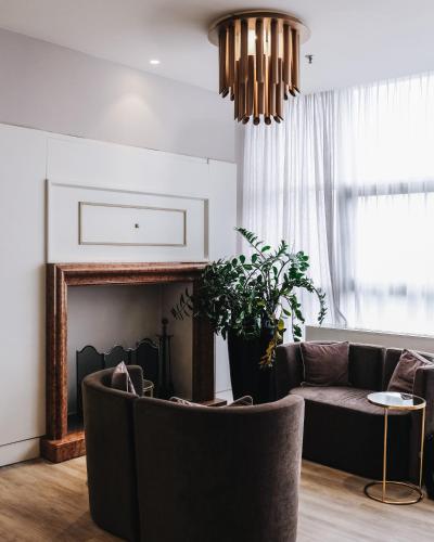 a living room with a couch and a fireplace at Best Western CTC Hotel Verona in San Giovanni Lupatoto