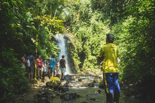 a group of people standing in front of a waterfall at Hotel Fazenda Dona Francisca in Joinville