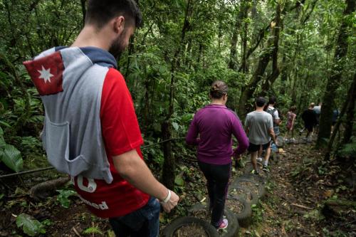 a group of people walking on a trail in the woods at Hotel Fazenda Dona Francisca in Joinville