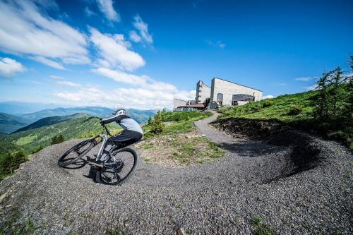 a person riding a bike on a gravel road at Haus am Römerbad in Bad Kleinkirchheim