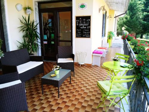 a patio with chairs and tables in front of a building at Hotel Ristorante El Caracol in Mulazzo