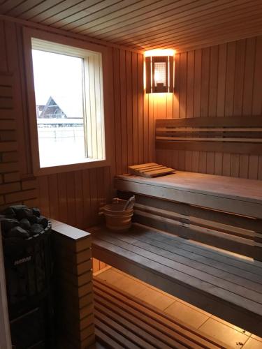 a sauna with a bench and a window at Рыбацкий домик in Mayaki