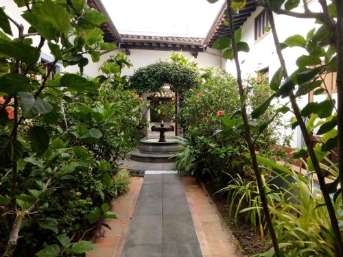 a garden with a fountain in the middle at Meson del Alferez Coatepec in Coatepec