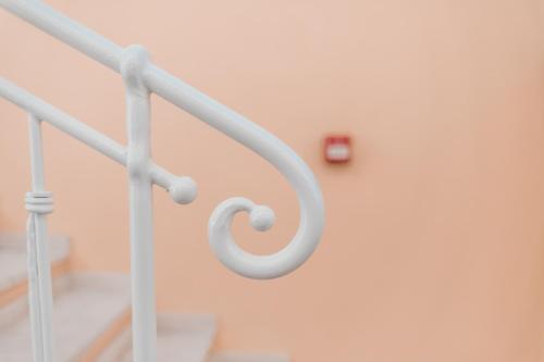 a white metal railing in a stair case at Hotel Fiore Di Maggio in Villasimius