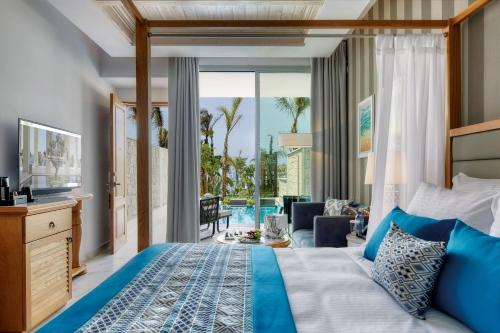a bedroom with a bed and a view of the ocean at Amavi, MadeForTwo Hotels - Paphos in Paphos