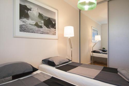 Un dormitorio con dos camas y un espejo. en After Six Apartment, en Bratislava