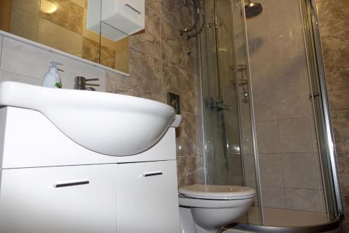 a bathroom with a sink and a shower and a toilet at Apartments Nevenka i Josko in Tučepi