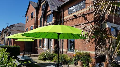 a green umbrella in front of a building at The Mon Fort in Bridlington