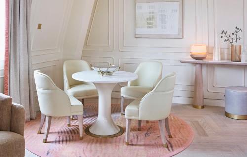 a dining room with a white table and chairs at One Aldwych in London