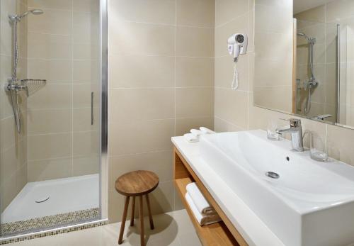 a bathroom with a sink and a shower at Urban Boutique Hotel in Tbilisi City