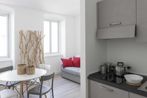 a kitchen and a living room with a table and chairs at Paduina3 Comfort Apartments in Trieste