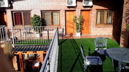 a patio with a table and chairs and a fence at Hotel Francia in San Rafael