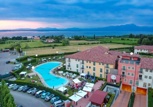 an aerial view of a resort with a pool at TH Lazise - Hotel Parchi Del Garda in Lazise