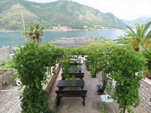 a patio with benches and a view of the water at Apartmani Jasmina in Kotor