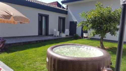 a wicker tub in the yard of a house at Dolce Vita in Zafferana Etnea