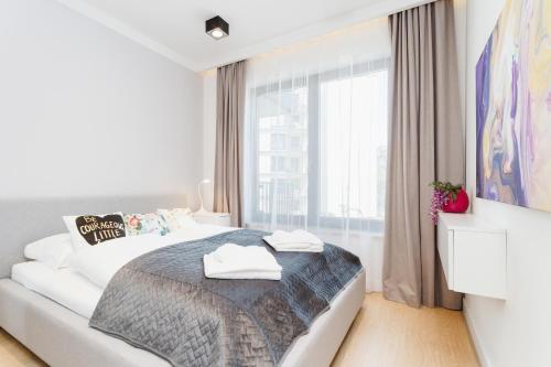 Postel nebo postele na pokoji v ubytování Apartments Kraków Przedwiośnie by Renters