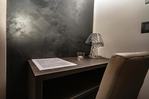 a table with a glass and a book on it at Alterego B&B in Milazzo