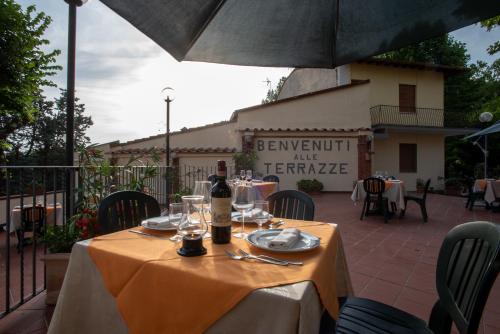 a table with a bottle of wine on top of it at Hotel Le Terrazze di Nappino in Trespiano