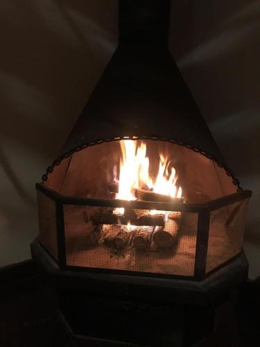a fire is burning in a light fixture at Pousada Recanto da Siriema in Monte Alegre do Sul