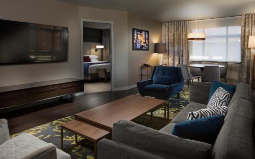 a living room with a couch and a tv at The Paramount Hotel in Seattle