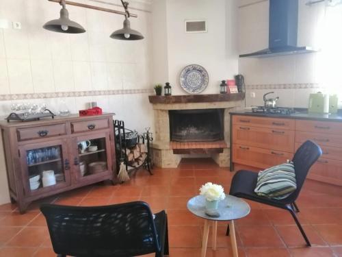 a kitchen with two chairs and a table and a stove at D´YELLOW HOUSE - Beach and Countryside in Carqueja