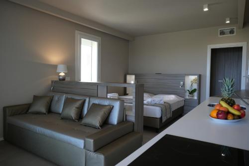 a living room with a couch and a bed at AlMar Apartments by Alma di Alghero in Alghero