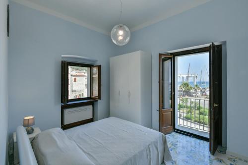a bedroom with a bed and a large window at Casa Vacanze Don Mimì in Acciaroli