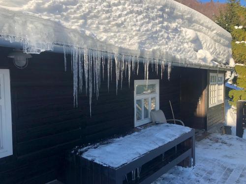 a house with icicles hanging from the roof at Chalupa Pri vleku. in Donovaly