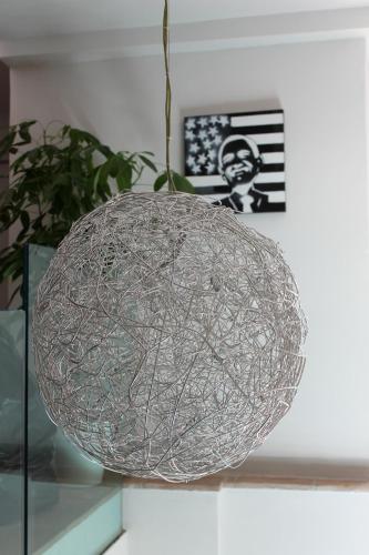 a metal ball on top of a glass table at Hotel Sorella Luna in Assisi