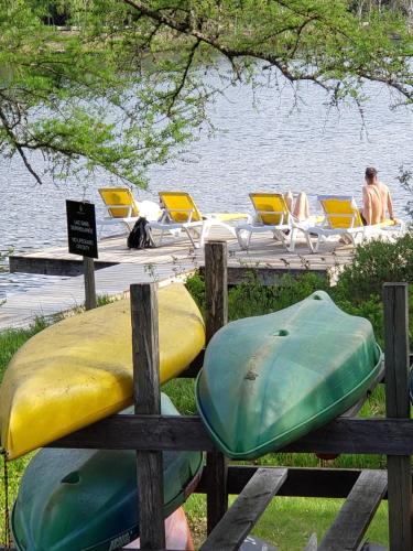 a bunch of kayaks sitting on a dock near the water at Chalet F116 Mont-Tremblant Nord in Lac-Superieur
