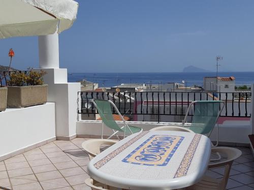 a table and two chairs on a balcony at Baia Unci in Canneto