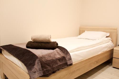 a bed with white sheets and a blanket on it at Cosmo Apartment Pleven in Pleven