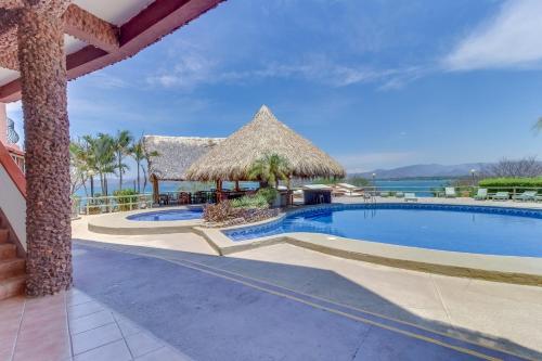 a pool at a resort with a view of the ocean at Flamingo Marina Resort in Playa Flamingo