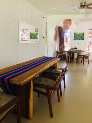 a room with a wooden table and chairs at Casa Bizu in Bacalar