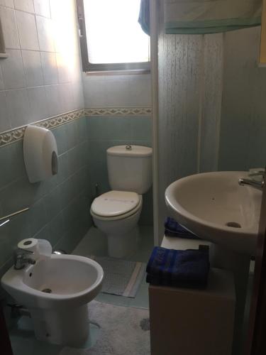 a bathroom with a toilet and a sink at Rudy Arenaile in Arenella