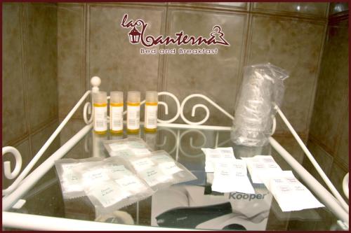 a glass table with bottles and packets on it at "B&B La Lanterna" Trulli & Dimore Storiche in Alberobello