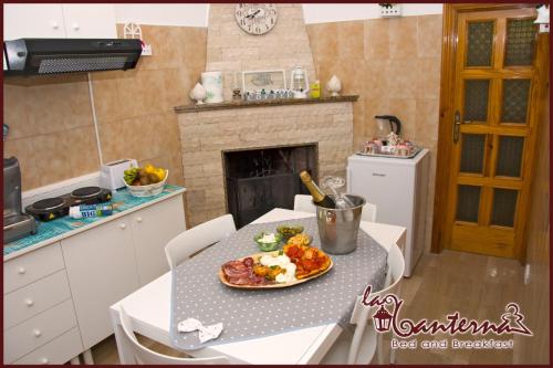 a kitchen with a table with a plate of food on it at "B&B La Lanterna" Trulli & Dimore Storiche in Alberobello