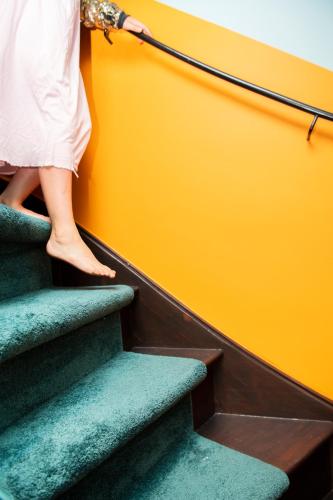 a woman is walking up the stairs at Hotel Bruno in Middelburg