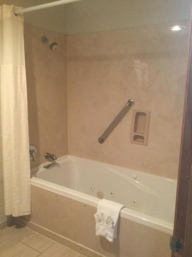 a bathroom with a bath tub with a towel at Baymont by Wyndham Cortez in Cortez